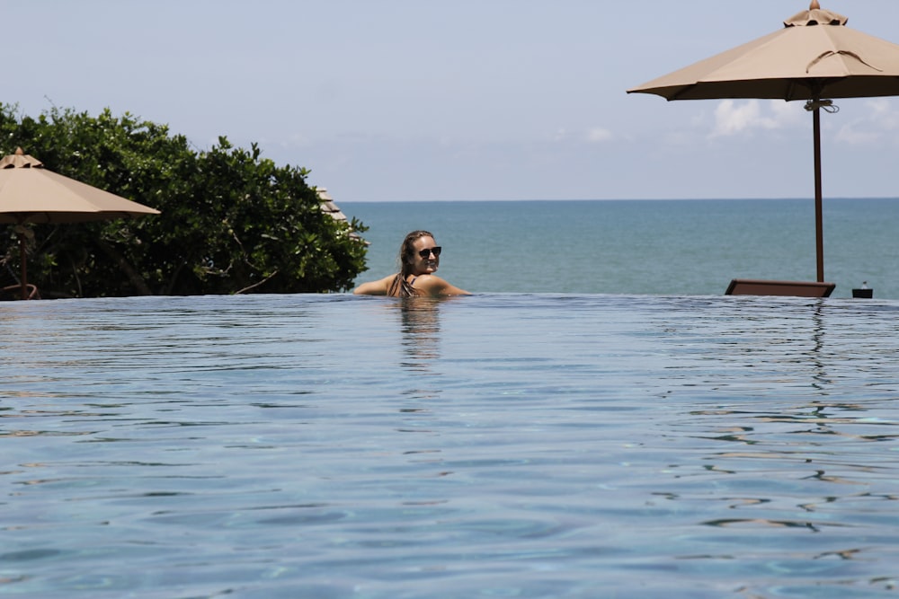 woman in swimming pool during daytime