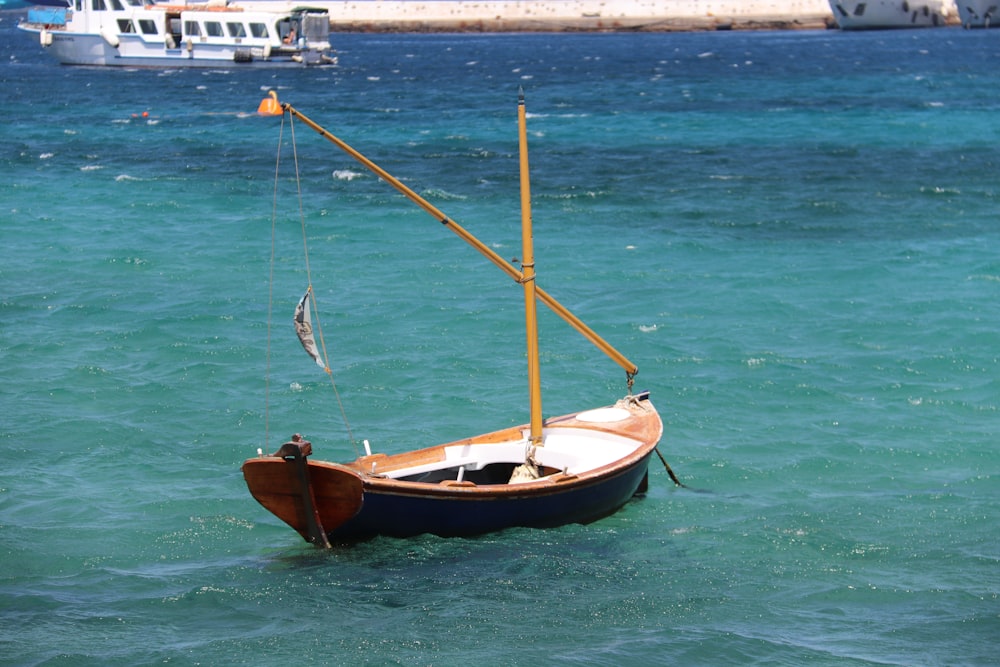 brown and white boat on sea during daytime