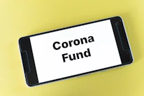 Close-up of hands holding a smartphone displaying a crowdfunding donation page.