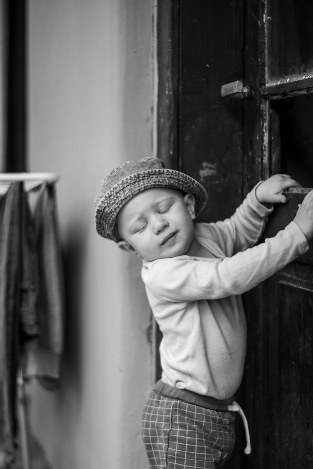 grayscale photo of girl in long sleeve shirt and hat