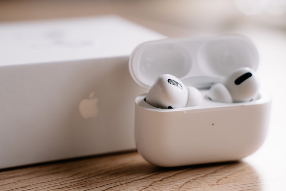 white apple earpods in white plastic case