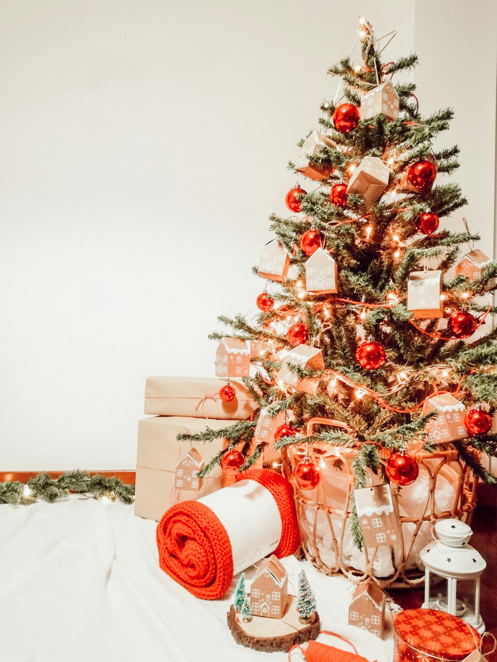 green and red christmas tree with baubles and gift boxes