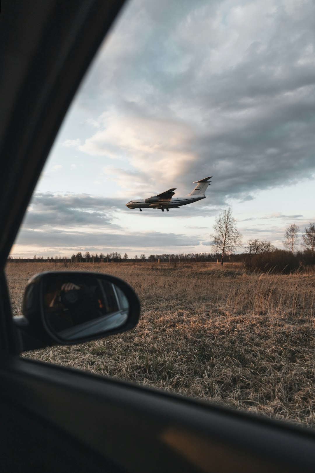 white and black airplane on brown grass field during daytime