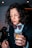 woman in black button up shirt holding clear drinking glass