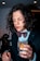 woman in black button up shirt holding clear drinking glass