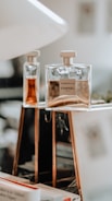 clear glass perfume bottle on white table