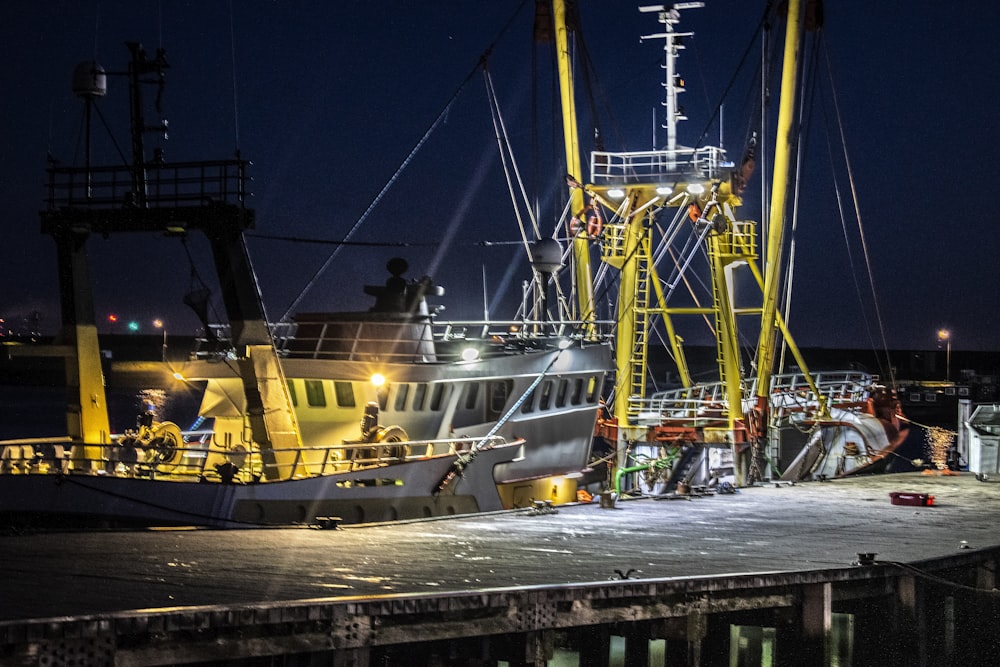 white and black ship on dock during night time