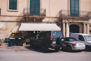 A compact car parked in front of a traditional Mauritanian market