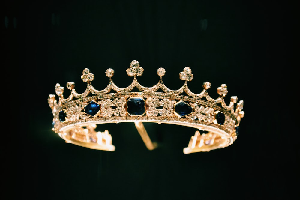 silver diamond studded crown with black background