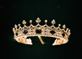 silver diamond studded crown with black background