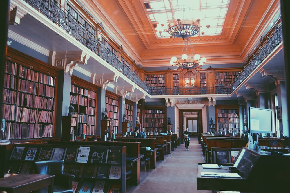 brown wooden book shelves in library