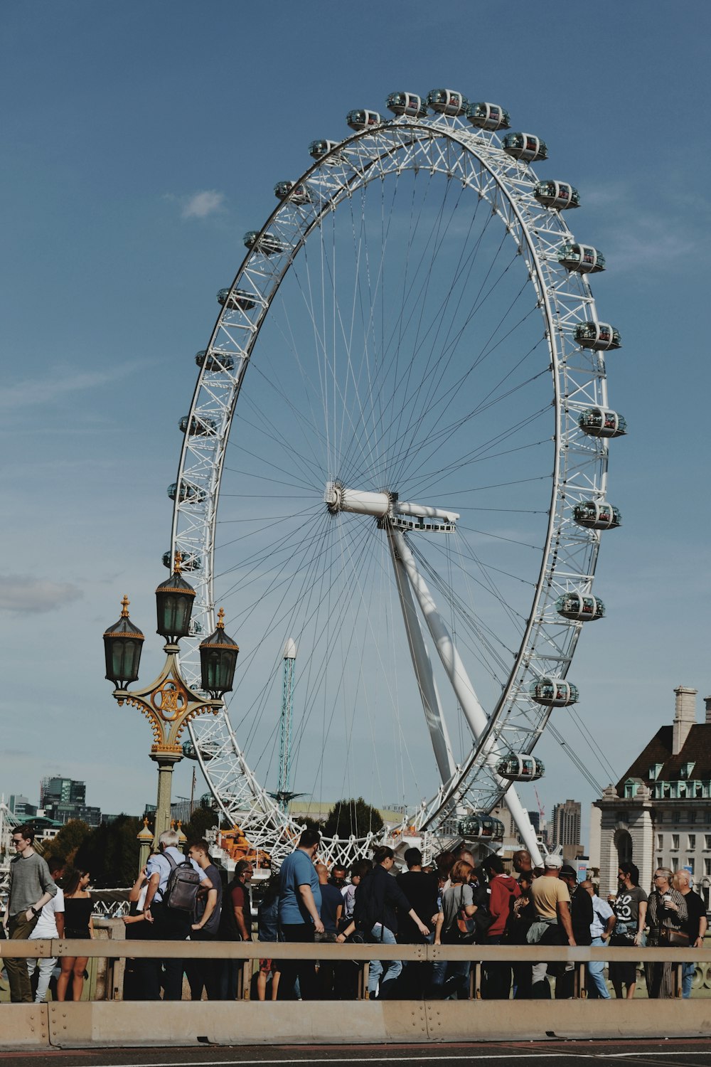 people walking on ferris wheel under blue sky during daytime