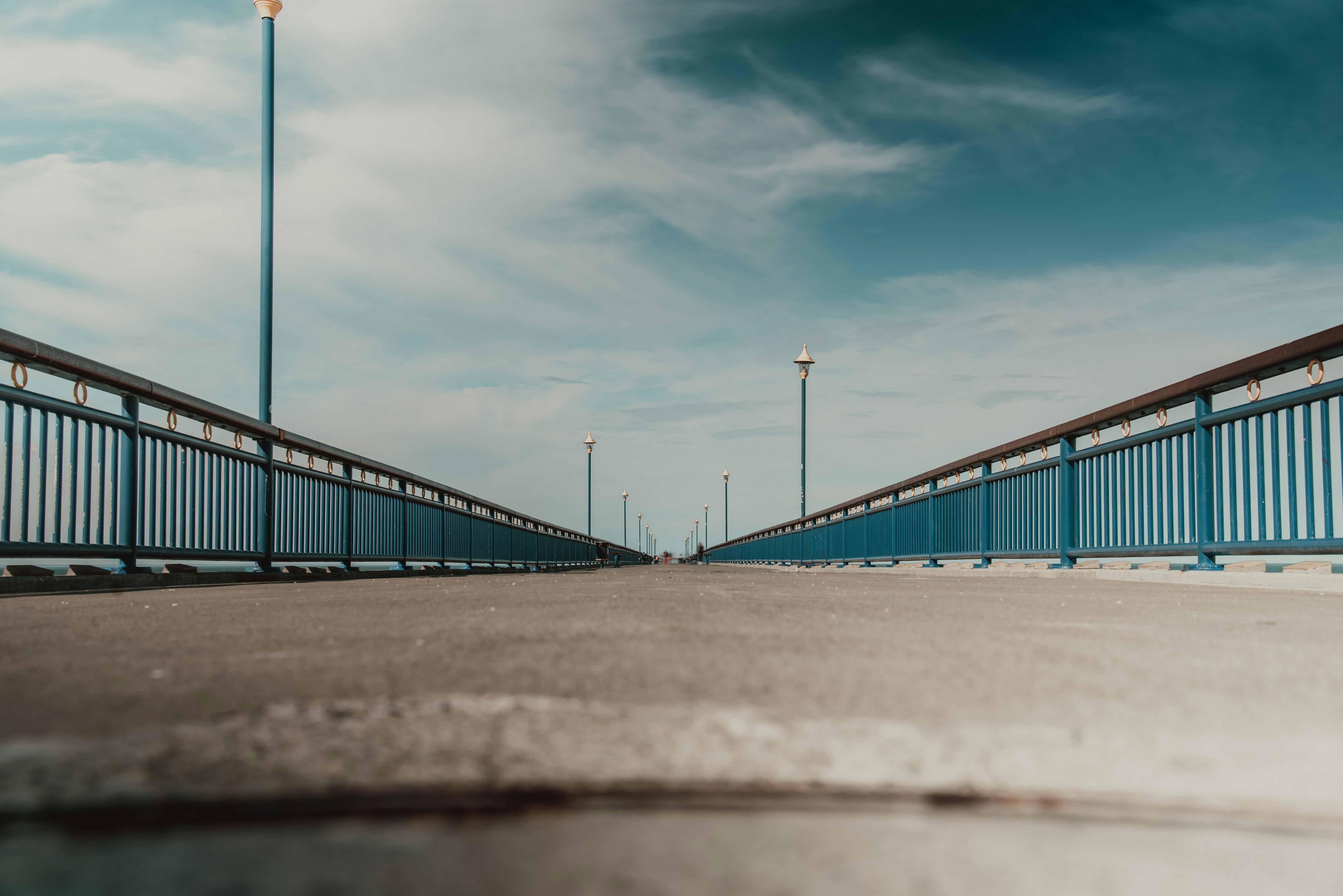 brown metal bridge under blue sky