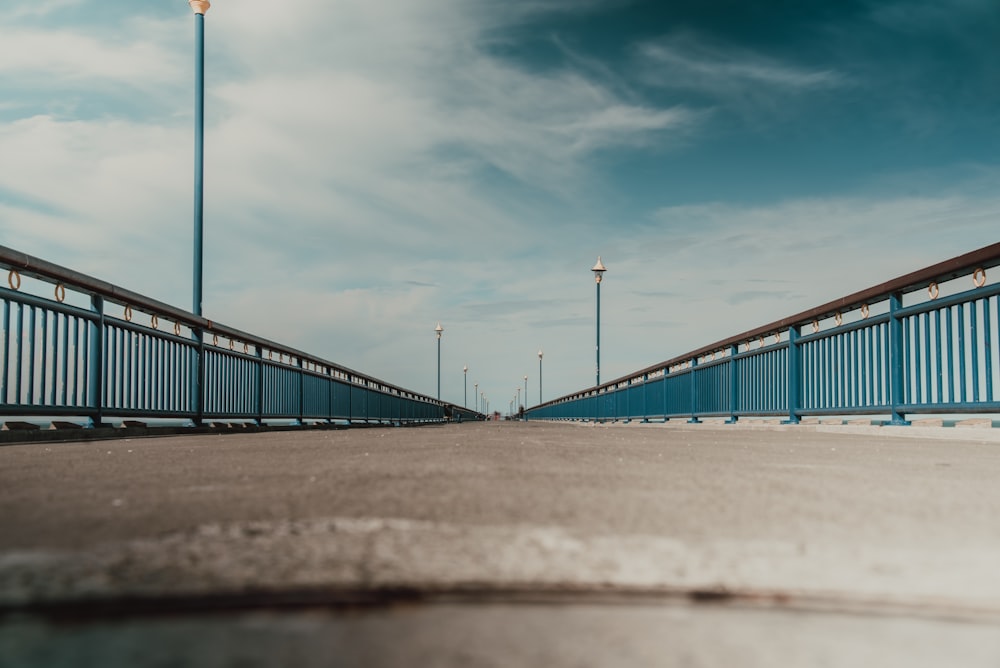 brown metal bridge under blue sky