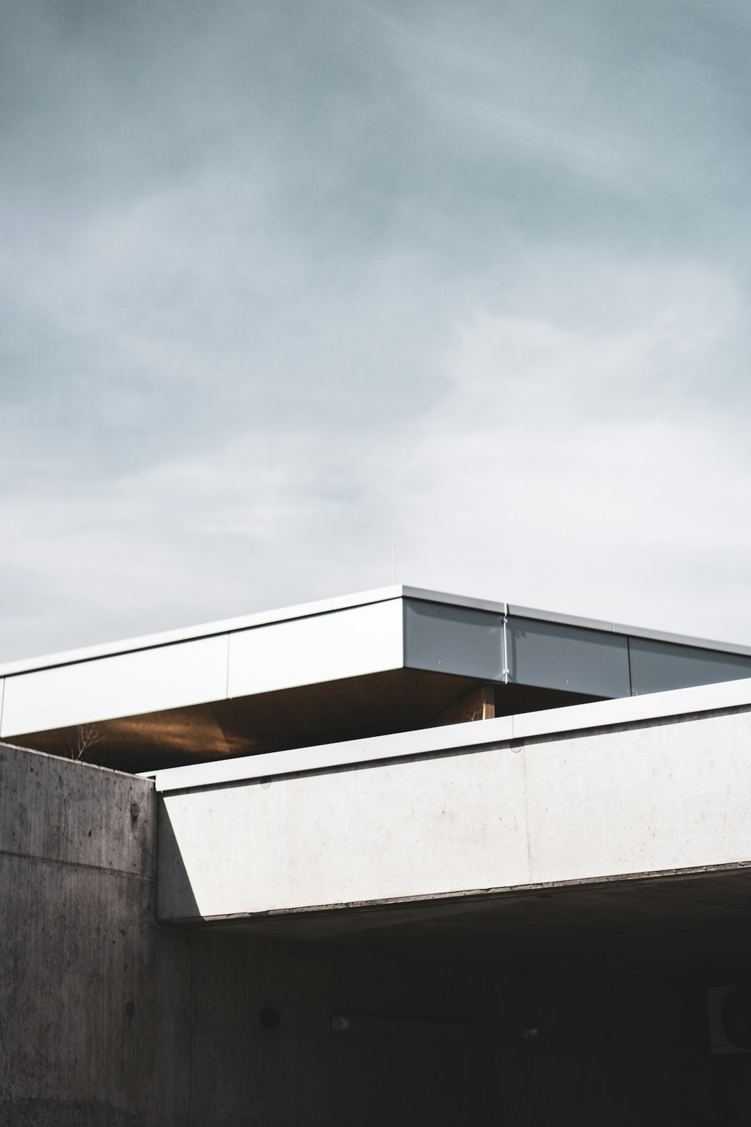 white concrete building under gray sky