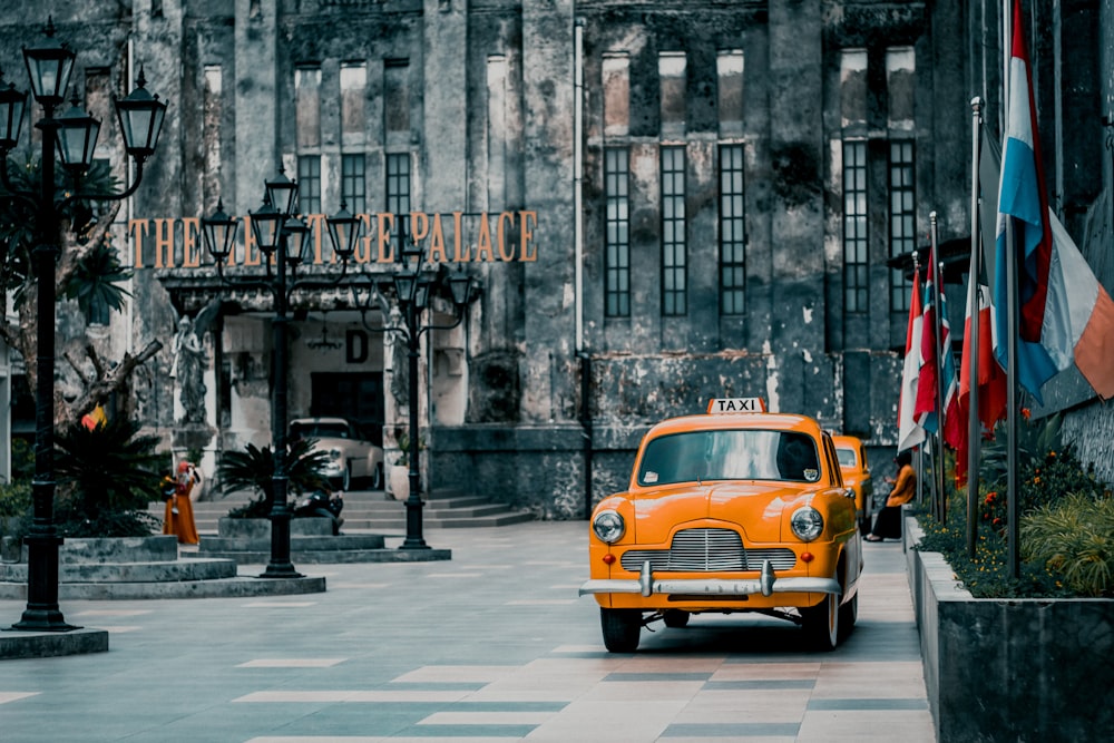 yellow taxi cab on street during daytime