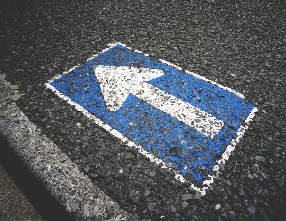 blue and white arrow sign