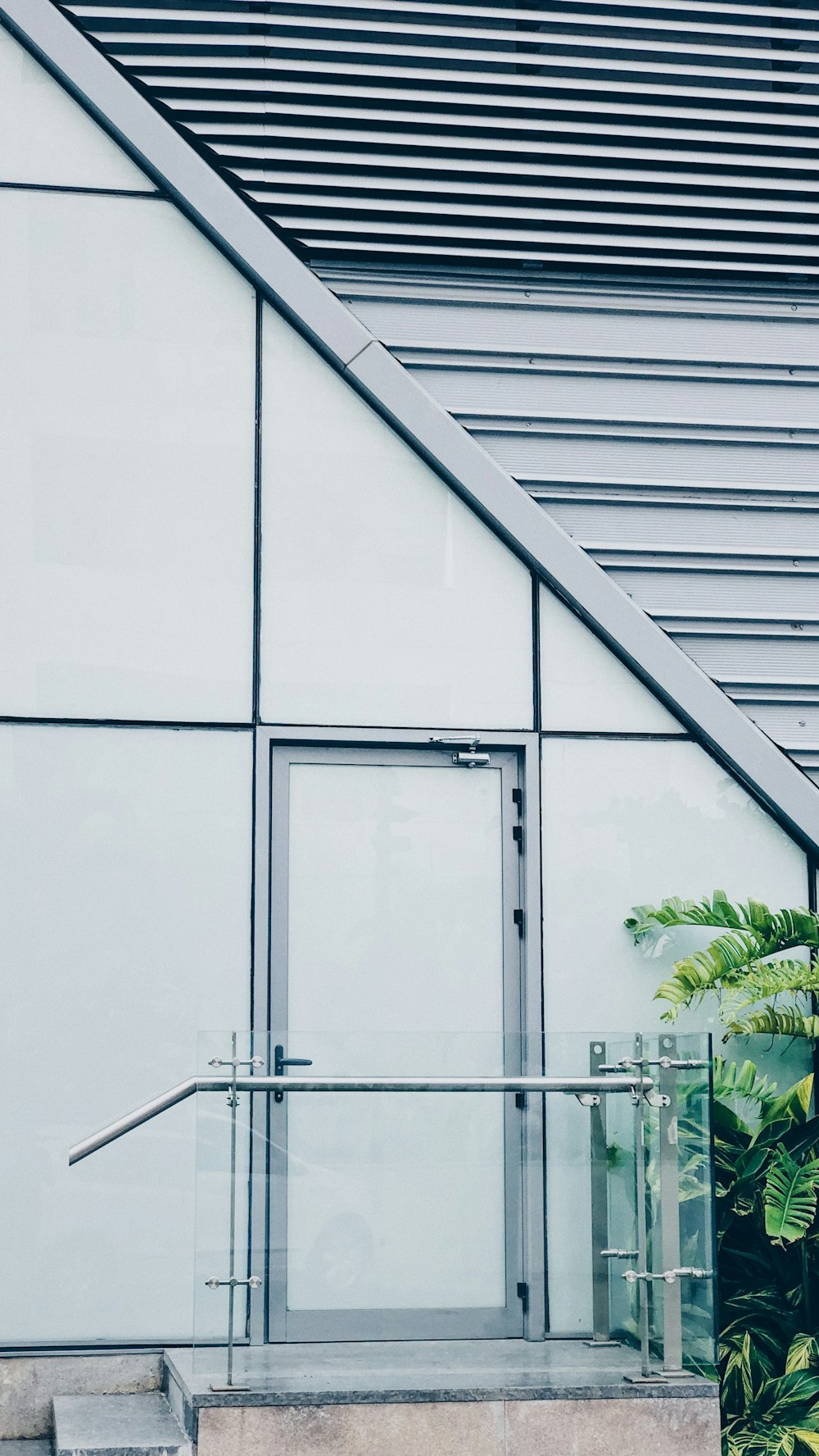 white concrete building with glass window