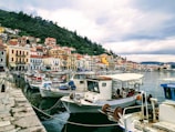 A vibrant coastal town with boats docked by the pier.