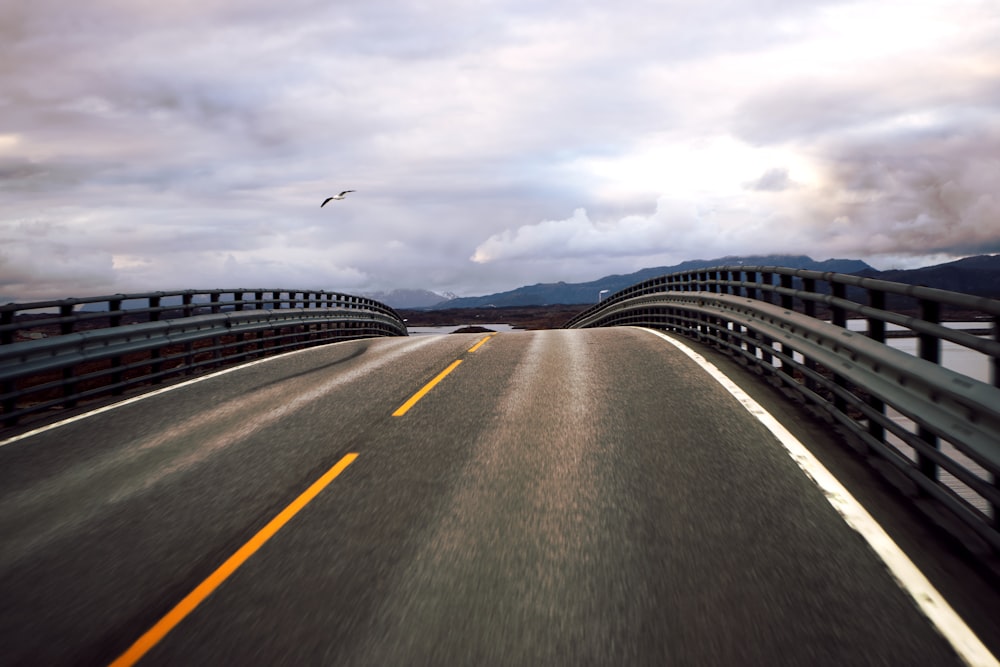 black asphalt road under cloudy sky during daytime