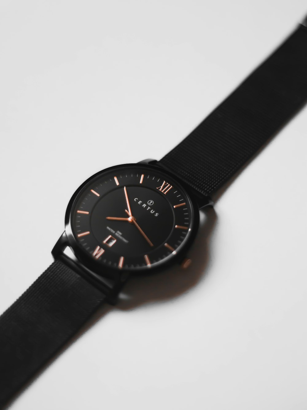 black analog watch at 10 10