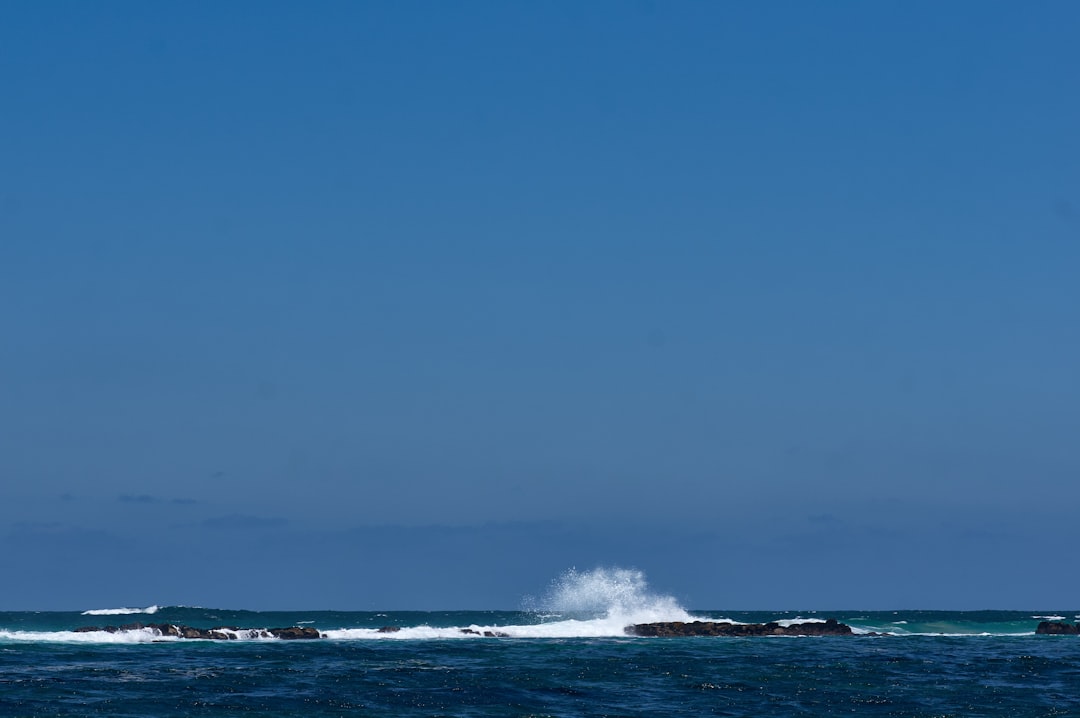 ocean waves under blue sky during daytime