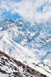 snow covered mountain under cloudy sky during daytime