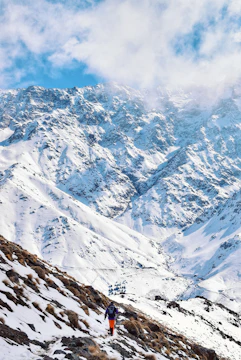 snow covered mountain under cloudy sky during daytime