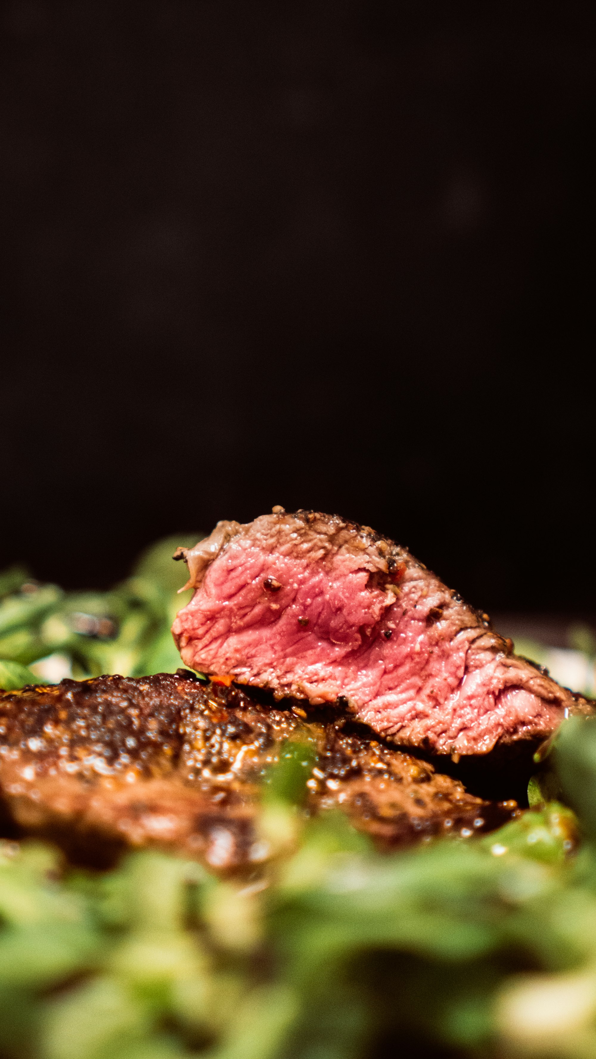 A medium steak, sliced into two pieces.