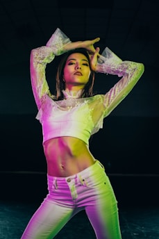 woman in yellow long sleeve crop top and pink shorts