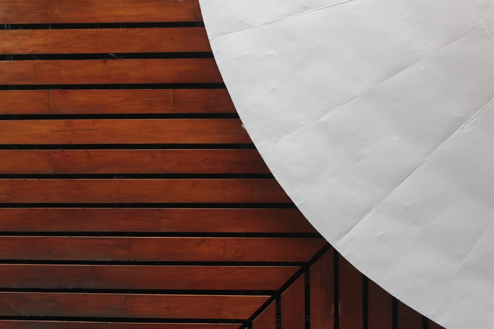 white round table near brown wooden wall