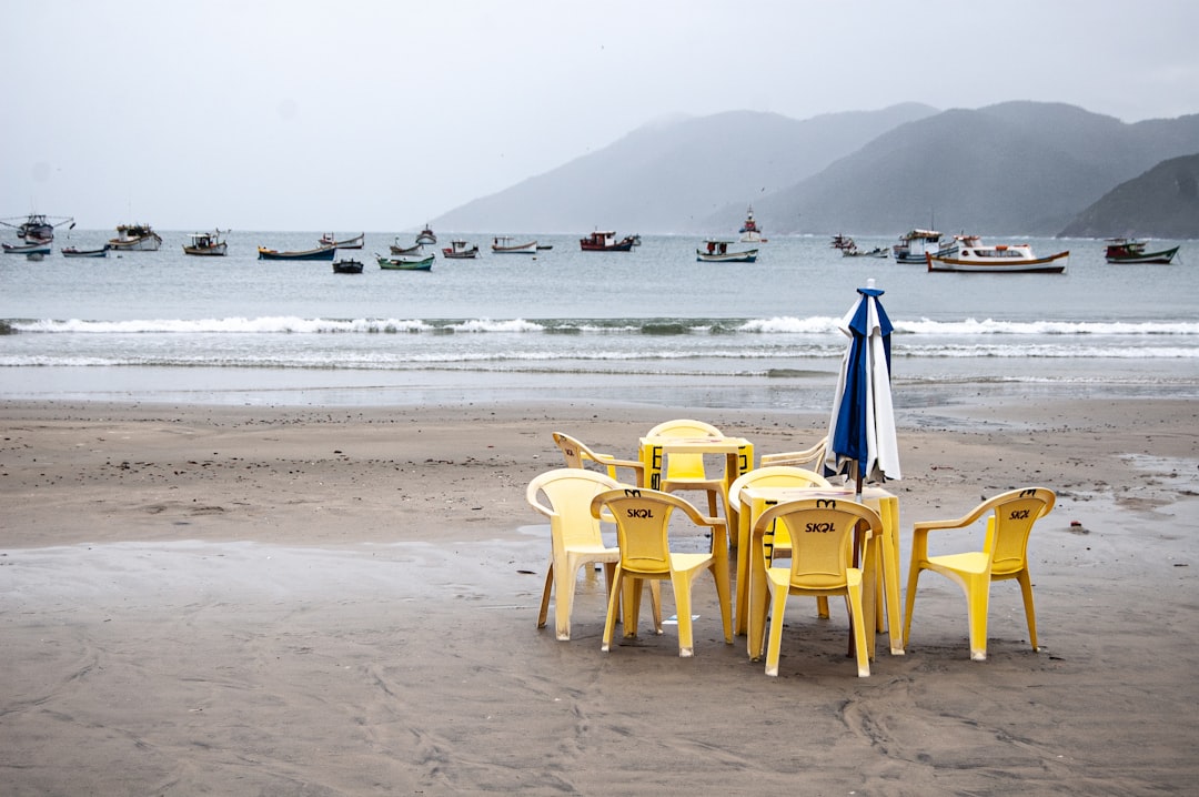 yellow plastic chair on beach during daytime