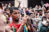 A lively workshop with trumpet players gathered around a teacher demonstrating techniques
