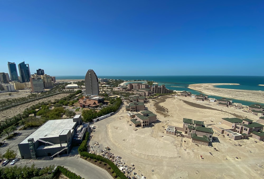 aerial view of city buildings near sea during daytime