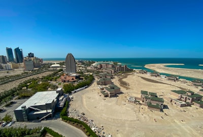 aerial view of city buildings near sea during daytime bahrain google meet background