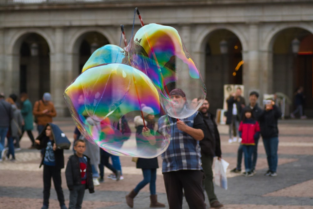 people walking on street with bubbles during daytime