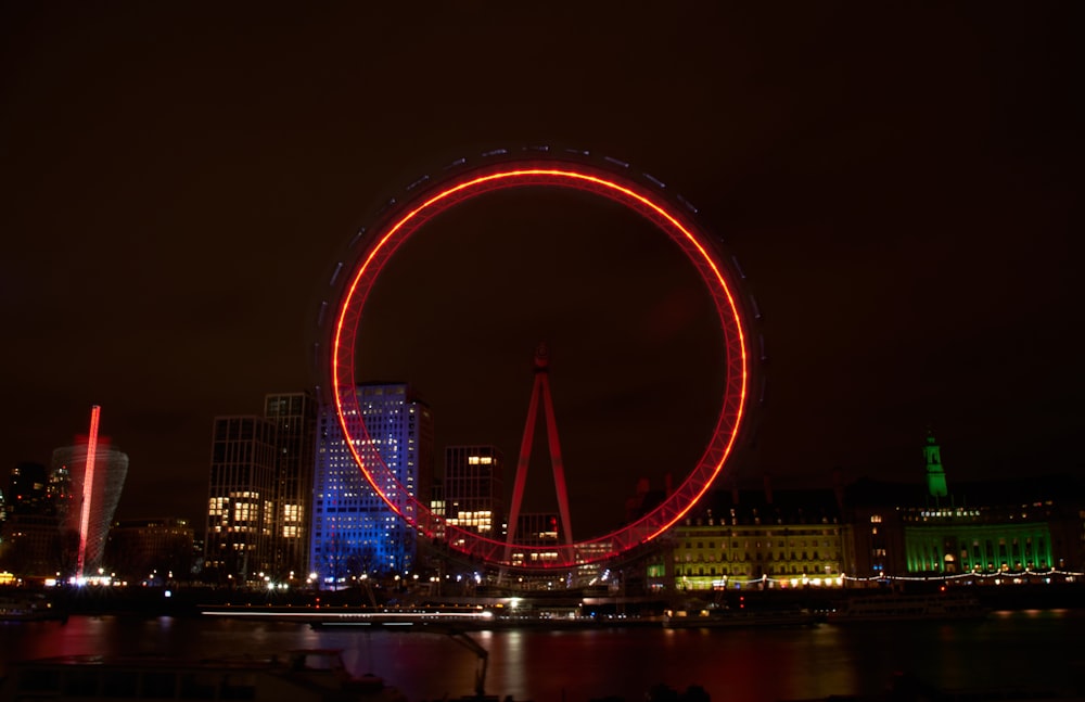 red lighted bridge over river during night time