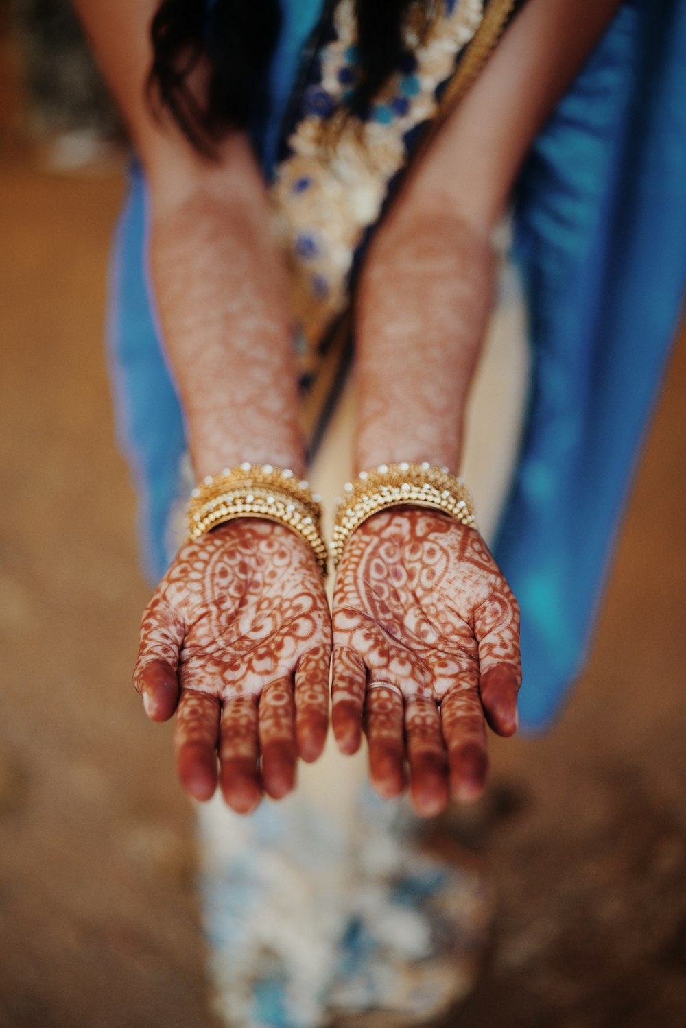 person wearing gold and silver bracelets