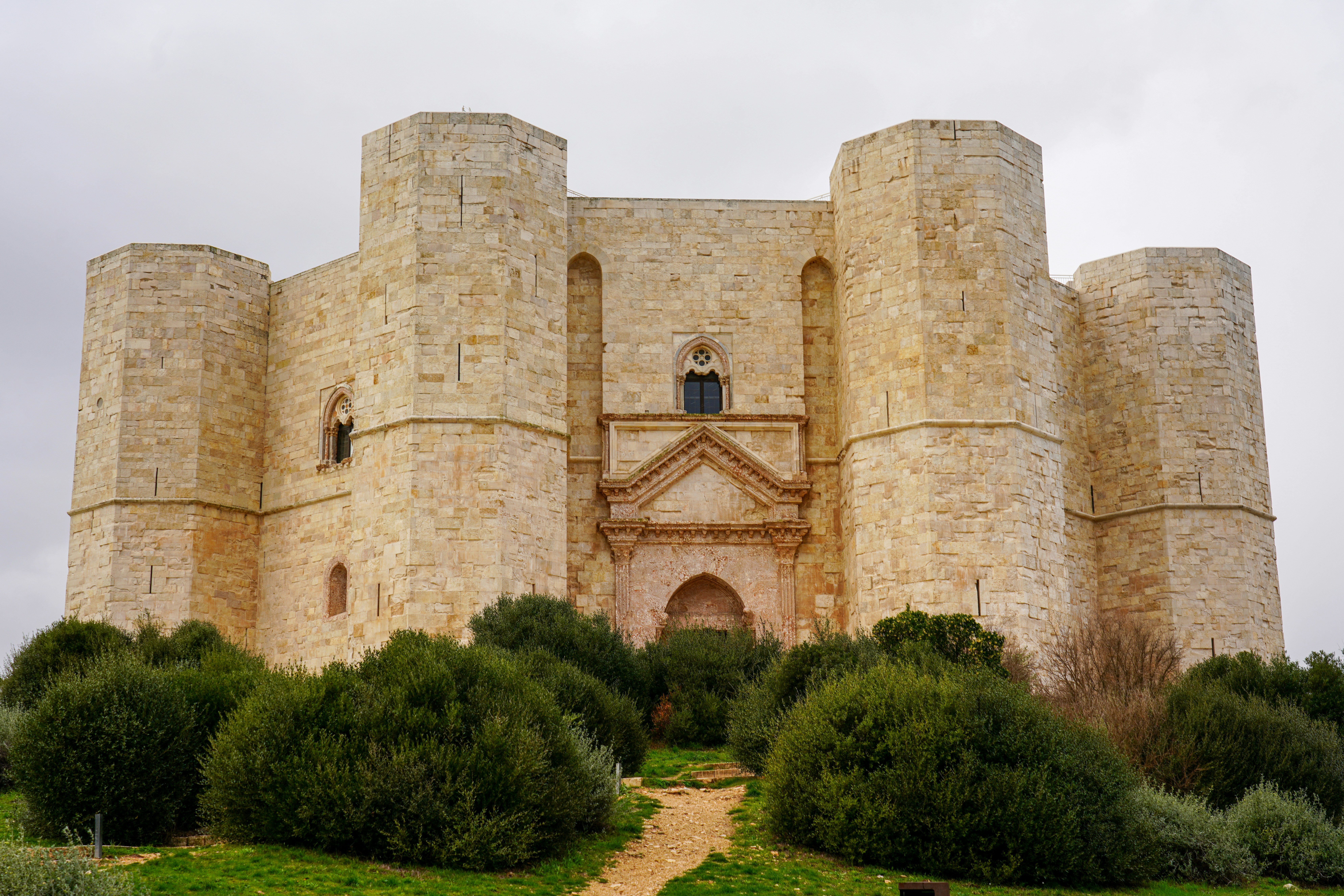 brown brick building near green grass field during daytime, 