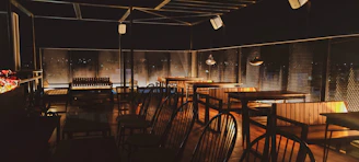 Elegant outdoor bar terrace at night with soft lighting and comfortable seating.
