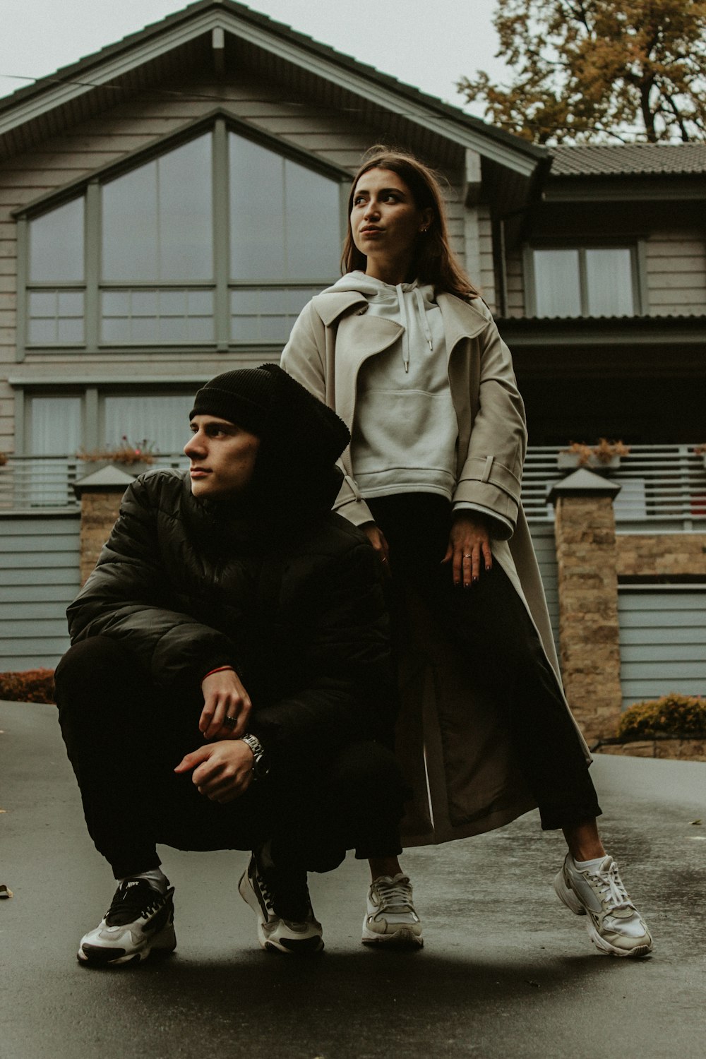 man in black jacket sitting beside woman in black coat