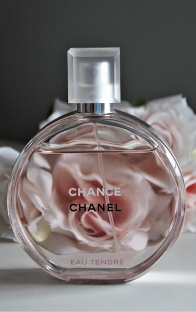 clear glass perfume bottle with pink liquid