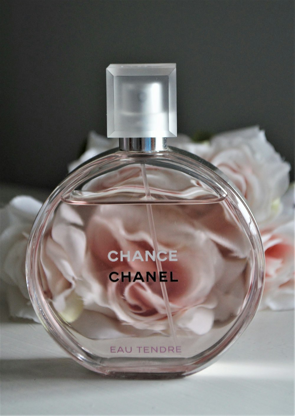 clear glass perfume bottle with pink liquid