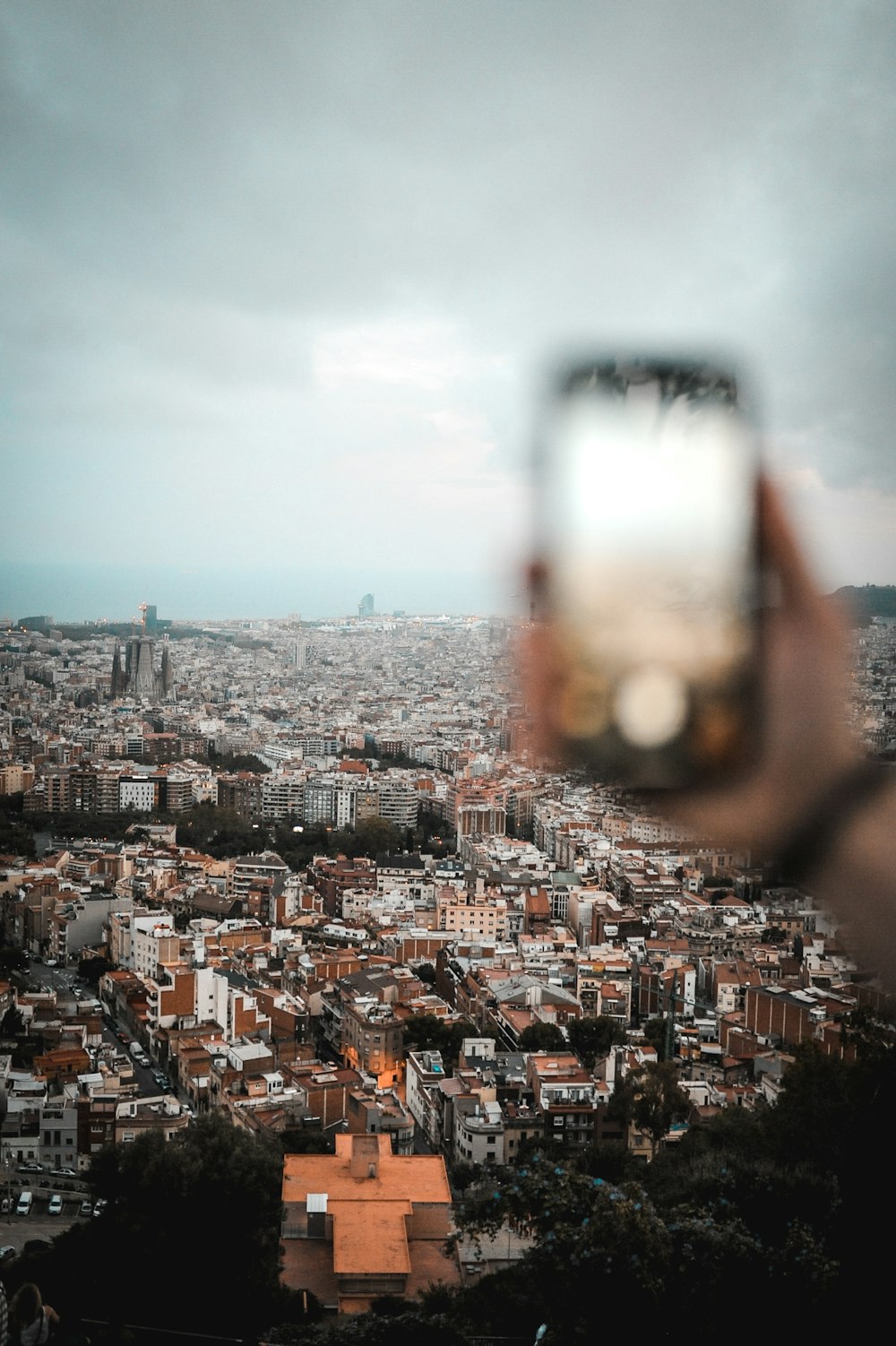 city with high rise buildings under white sky during daytime