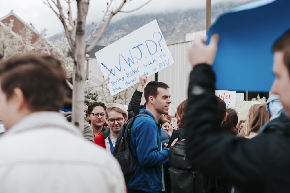 people holding white printer paper during daytime