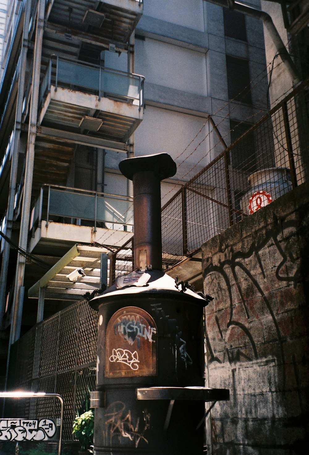 black and brown metal trash bin