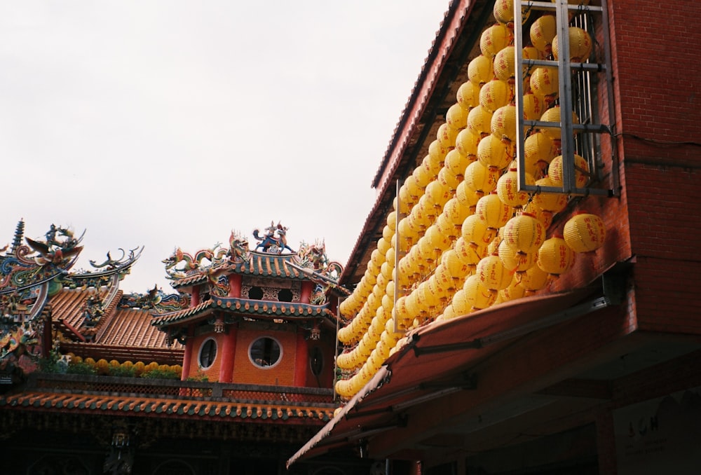 yellow fruit on brown wooden roof during daytime
