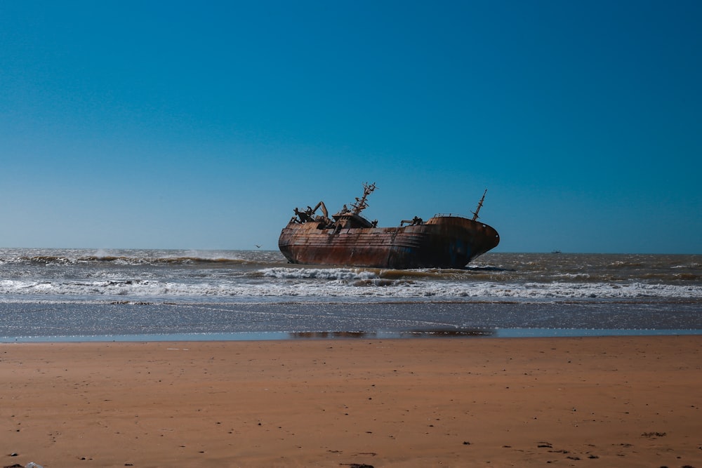 brown ship on sea shore during daytime