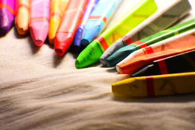 Close-up of colorful marbled crayon lego figures arranged artistically on a white background.