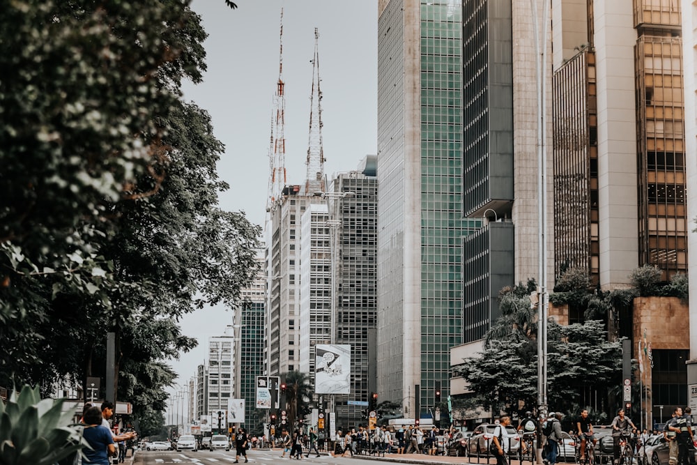 people walking on street near high rise buildings during daytime